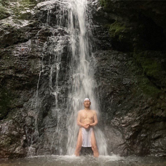 standing under the waterfall